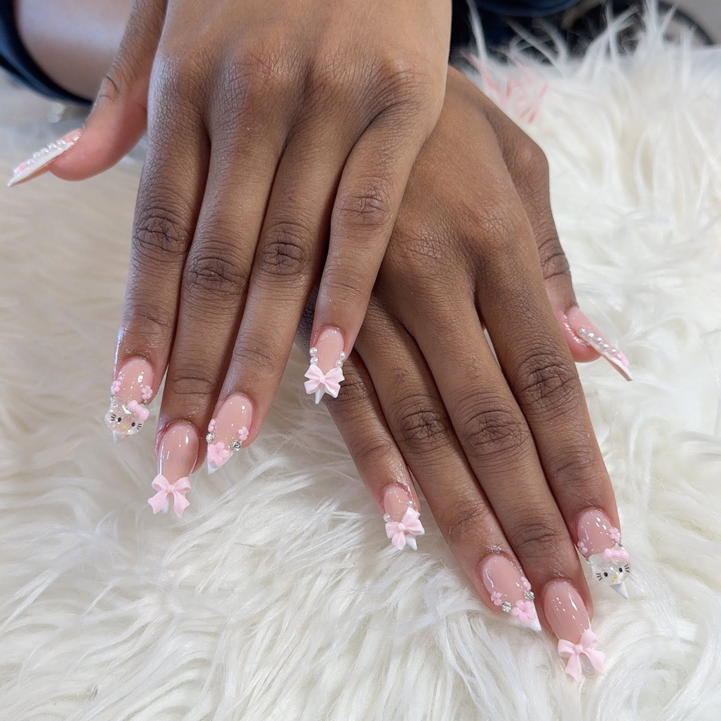 Detailed pink bow nail art created at Glo Nail Spa