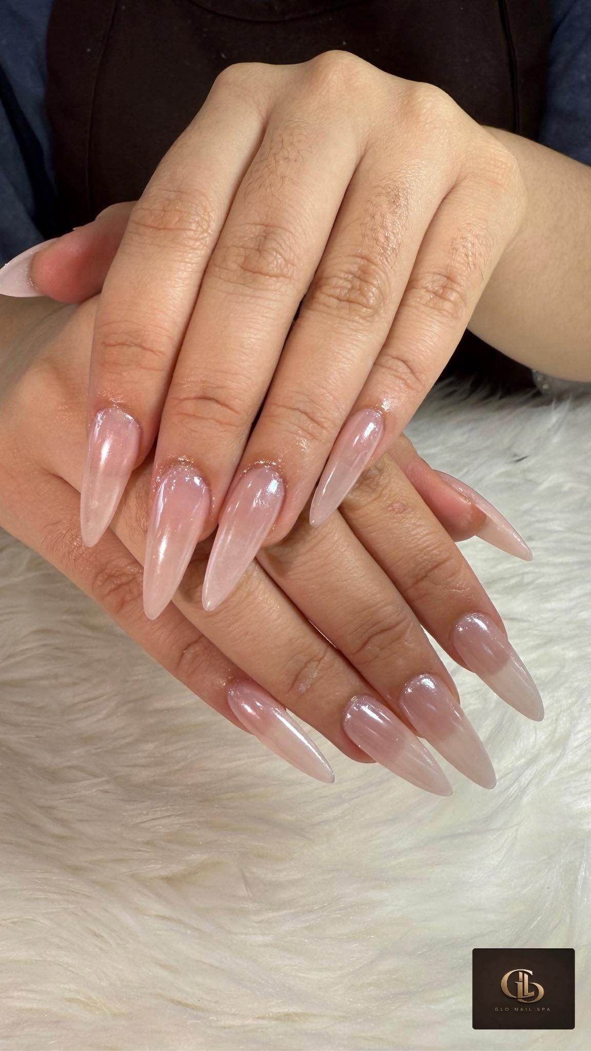 Glossy nude stiletto manicure