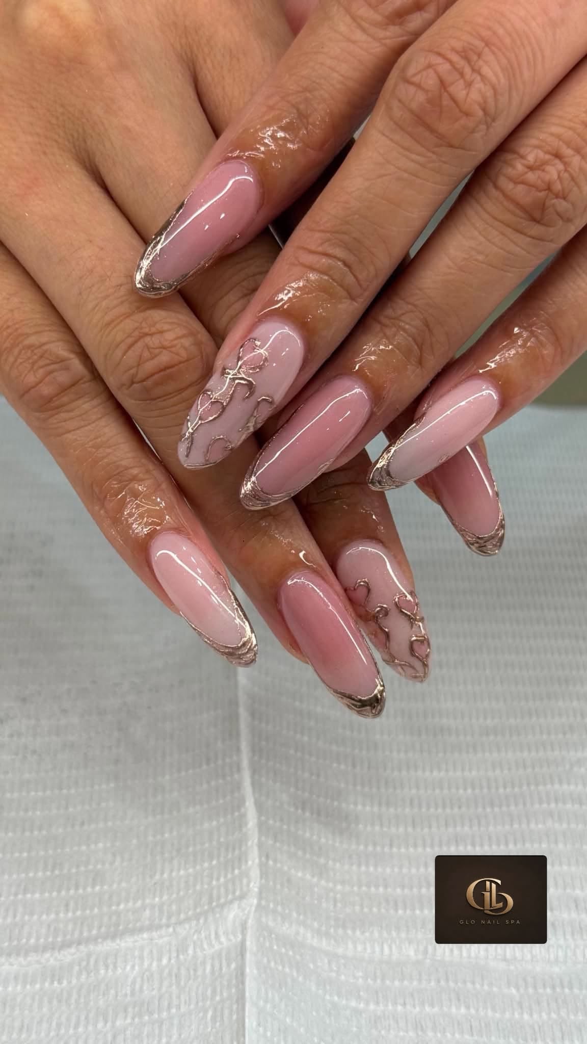 Rose gold metallic French manicure created at Glo Nail Spa